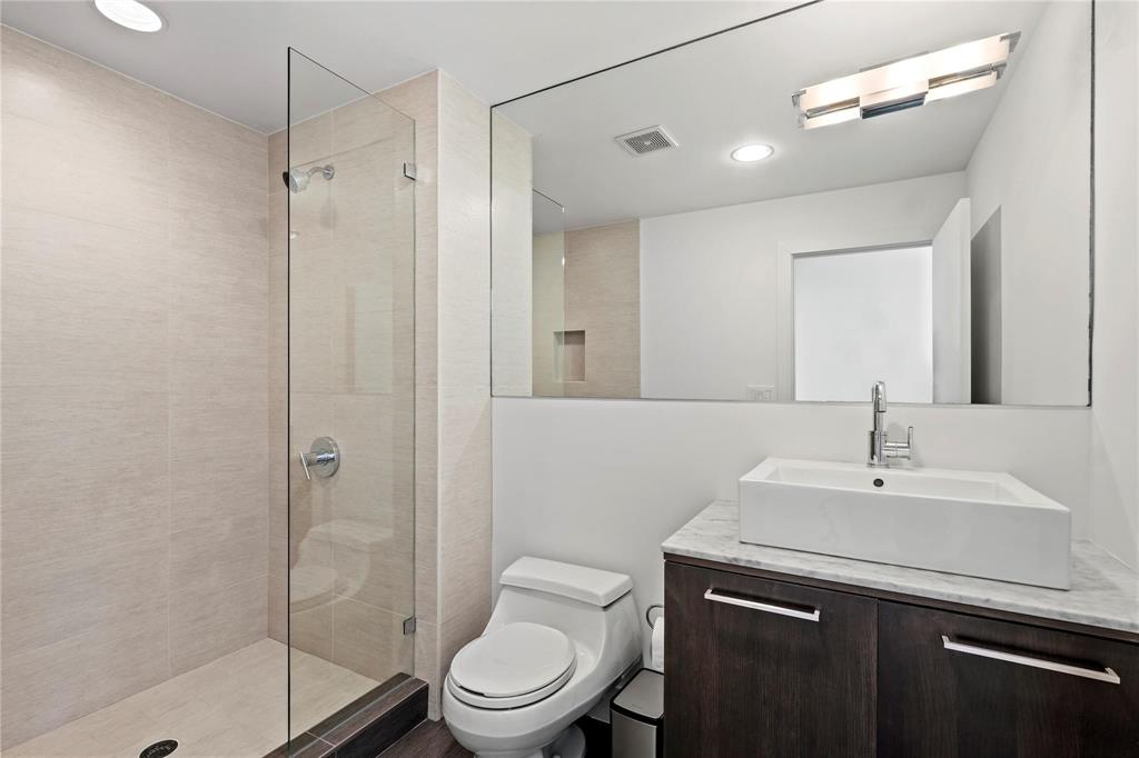 6 Vanguard Way Dallas, TX 75243 - Photo 21 of 35 a bathroom with a sink a toilet and shower