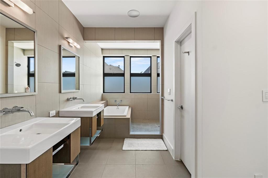 6 Vanguard Way Dallas, TX 75243 - Photo 27 of 35 a spacious bathroom with a double vanity sink a mirror and a bathtub
