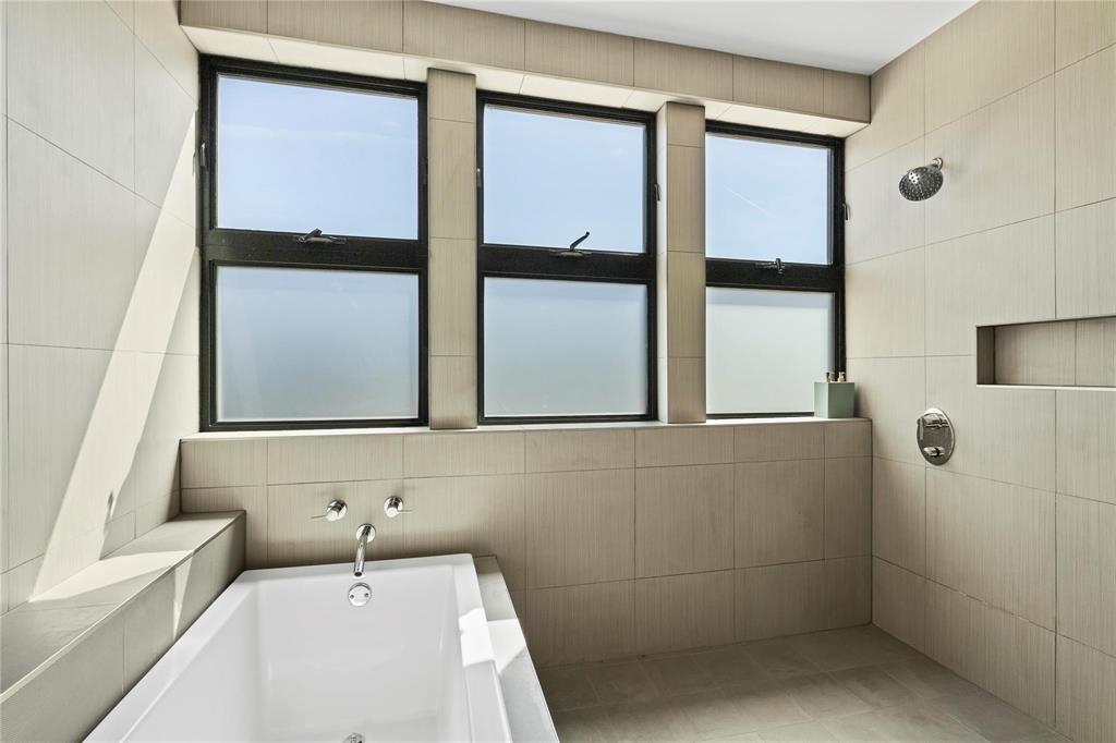 6 Vanguard Way Dallas, TX 75243 - Photo 28 of 35 a bathroom with a bathtub and a shower