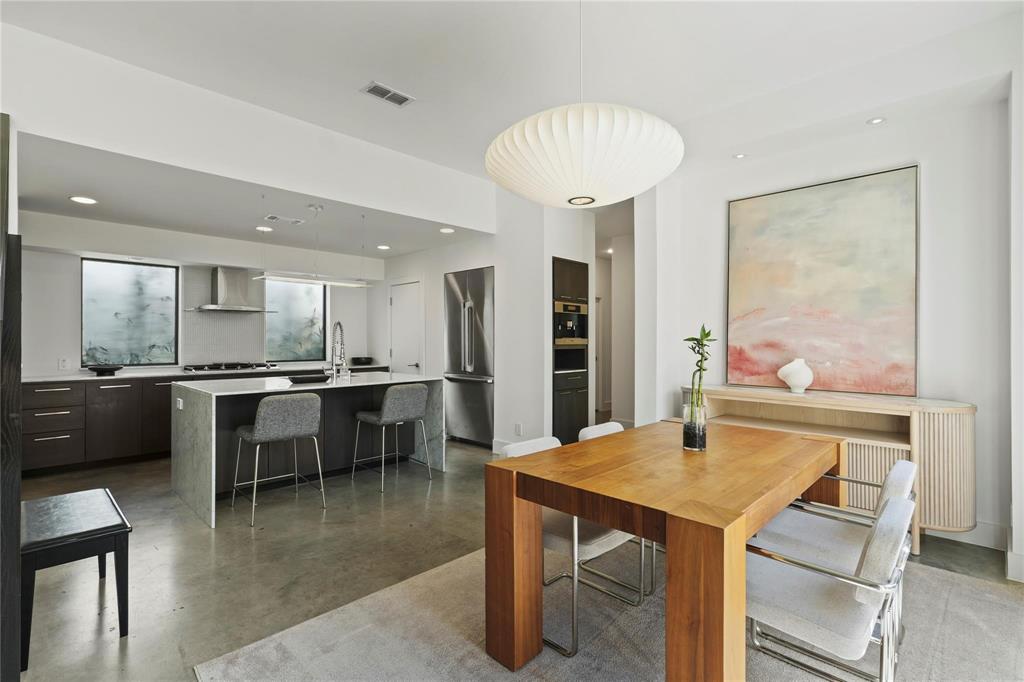 6 Vanguard Way Dallas, TX 75243 - Photo 9 of 35 a kitchen with a table and chairs in it