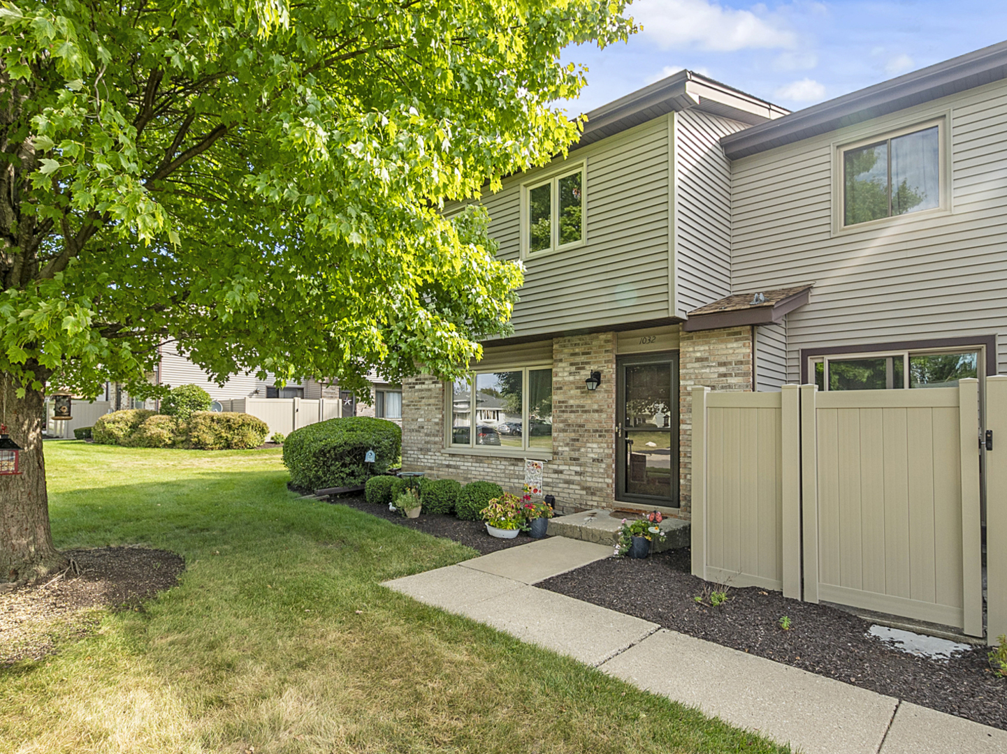 1032 Schoolgate Road New Lenox, IL 60451 - Photo 1 of 23 a front view of a house with a garden