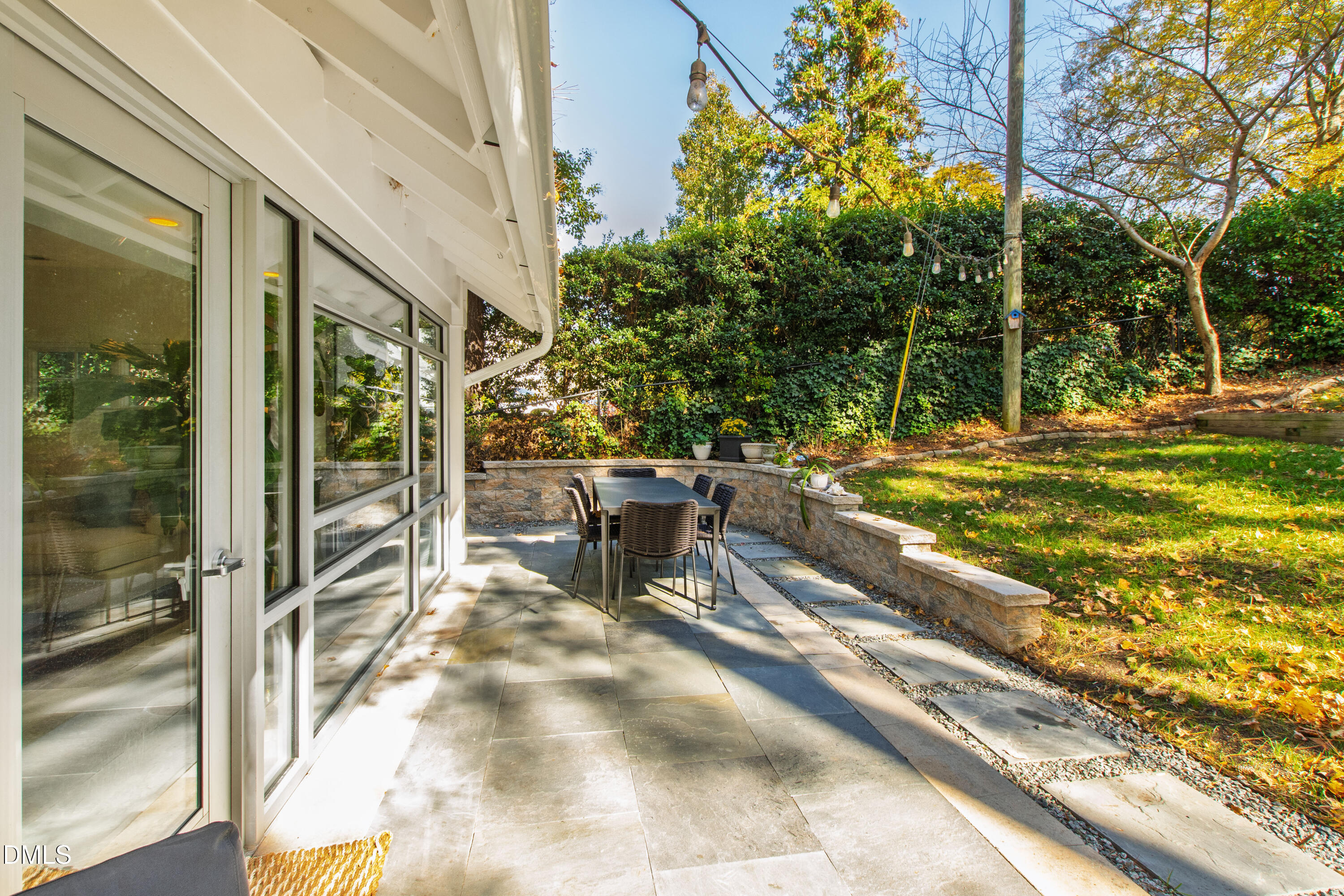 2803 Wayland Drive Raleigh, NC 27608 - Photo 18 of 40 a view of a patio with a table and chairs and potted plants