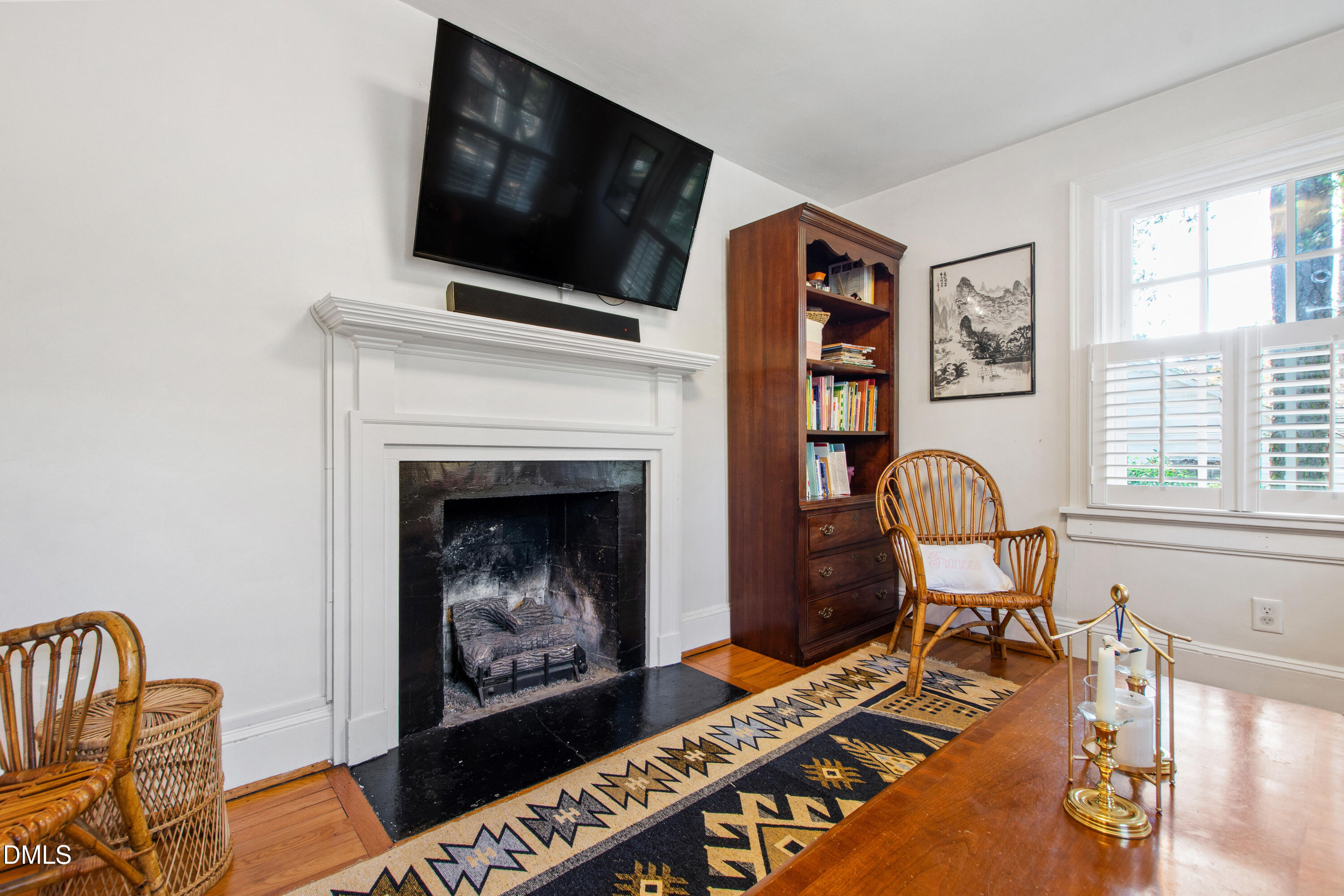 2803 Wayland Drive Raleigh, NC 27608 - Photo 29 of 40 a living room with furniture a flat screen tv and a fireplace