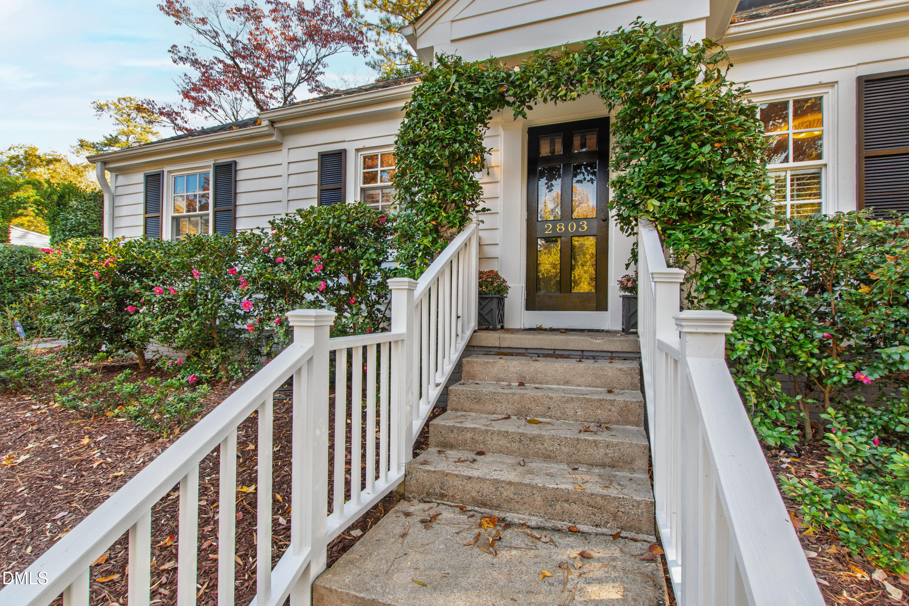 2803 Wayland Drive Raleigh, NC 27608 - Photo 40 of 40 a view of a house with wooden door and a flower garden