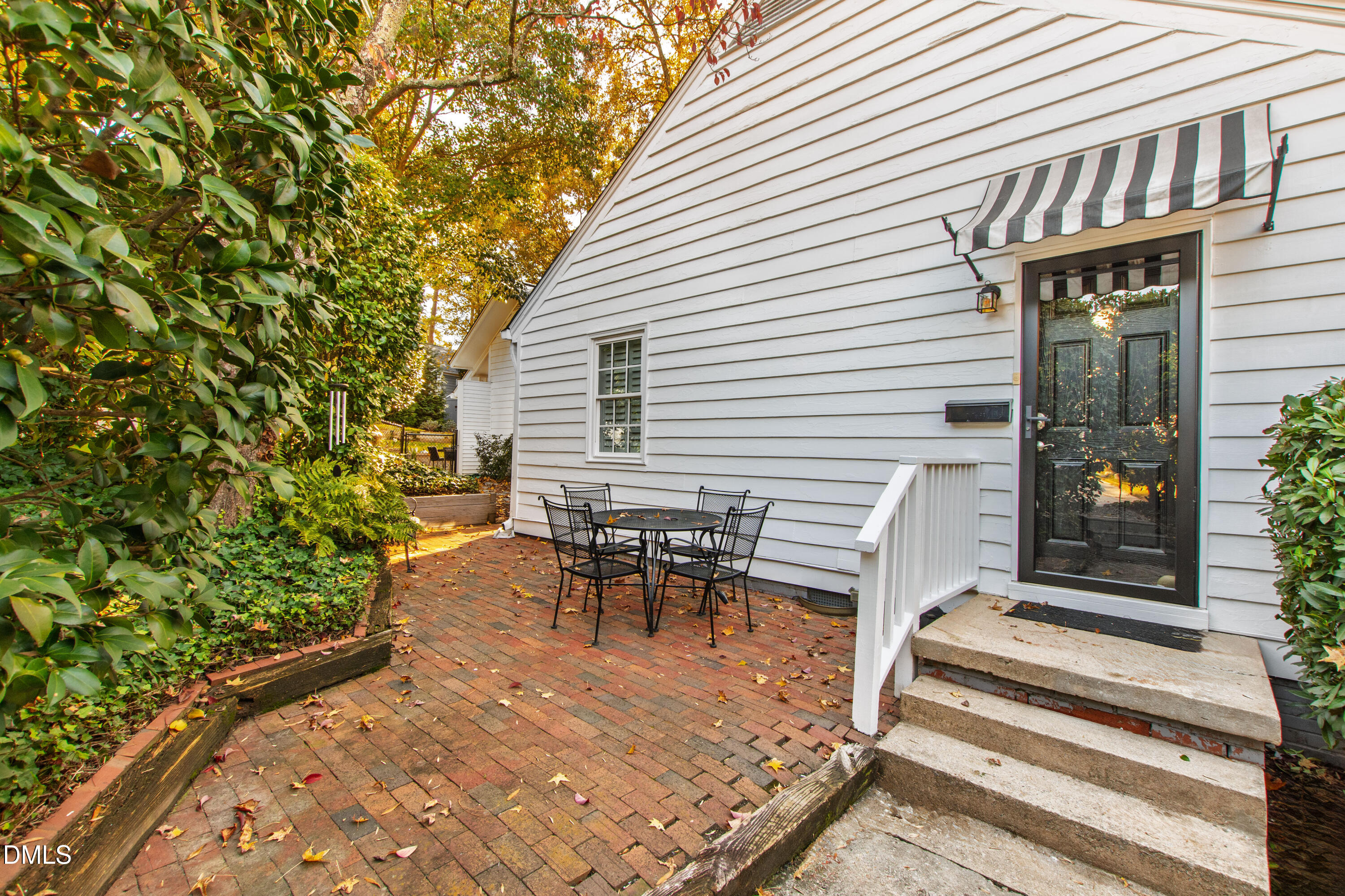 2803 Wayland Drive Raleigh, NC 27608 - Photo 5 of 40 a view of a patio with table and chairs with wooden floor and plants