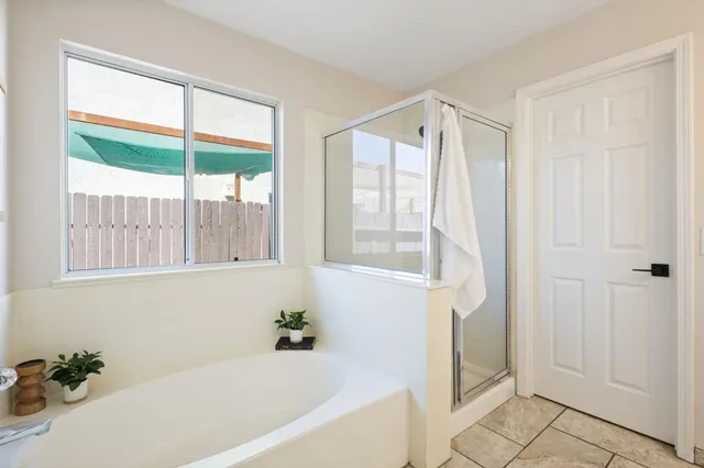 a bathroom with a bathtub and a shower