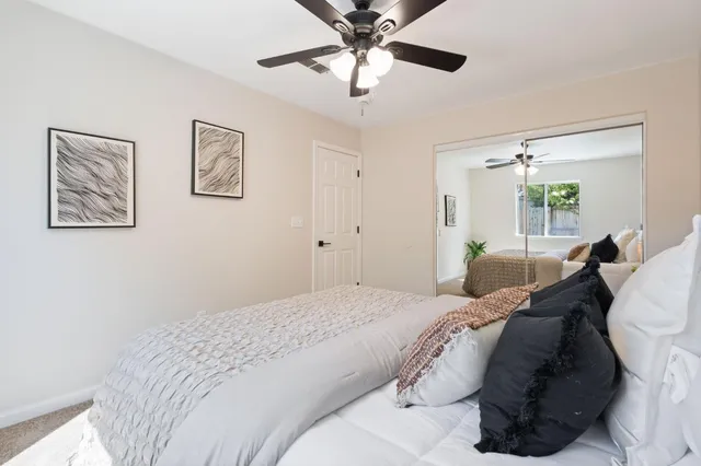a bedroom with a bed and a chandelier