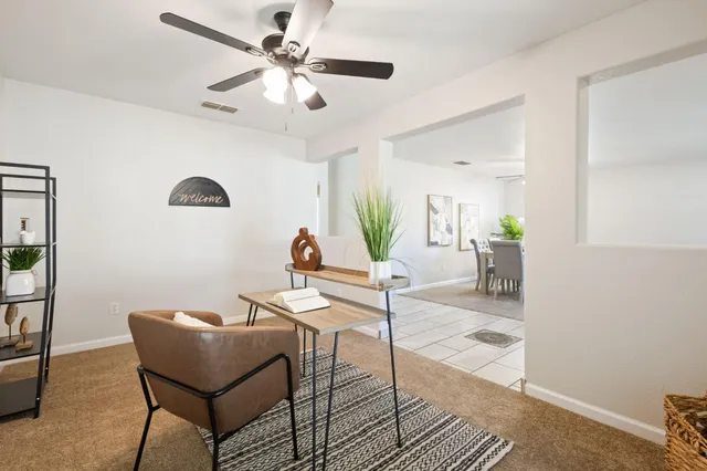 a view of a livingroom with furniture and a dining table