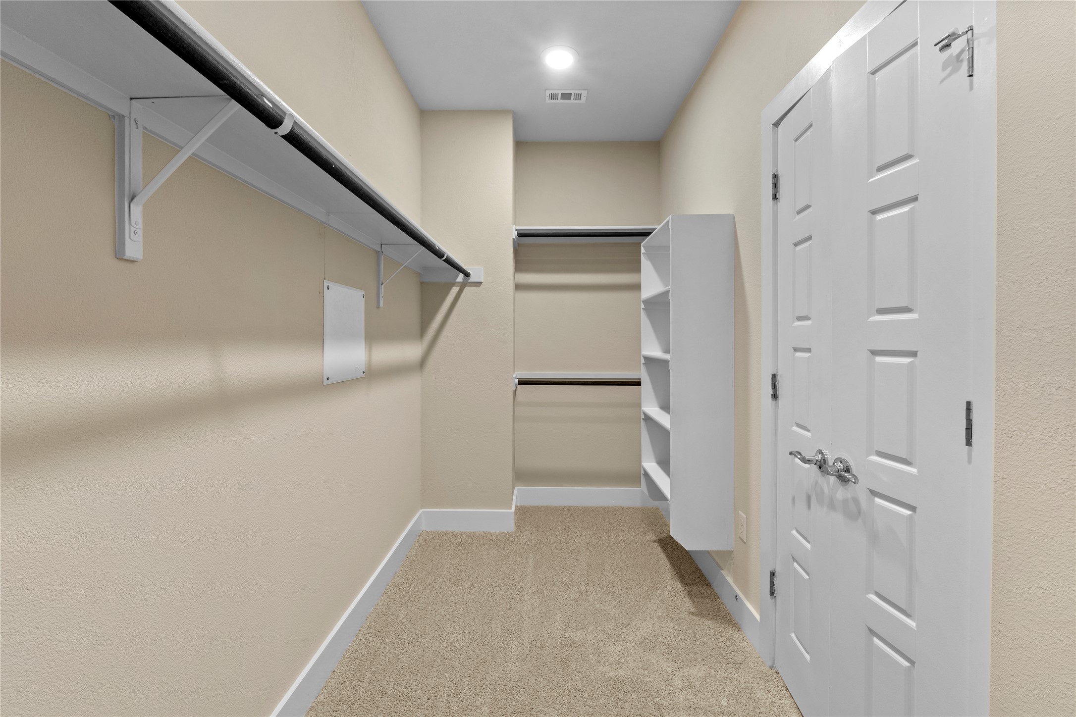 1709 Lawrence Street, Unit 5 Austin, TX 78741 - Photo 28 of 40 Ample built-in shelving and soft carpeting define this functional walk-in closet space.