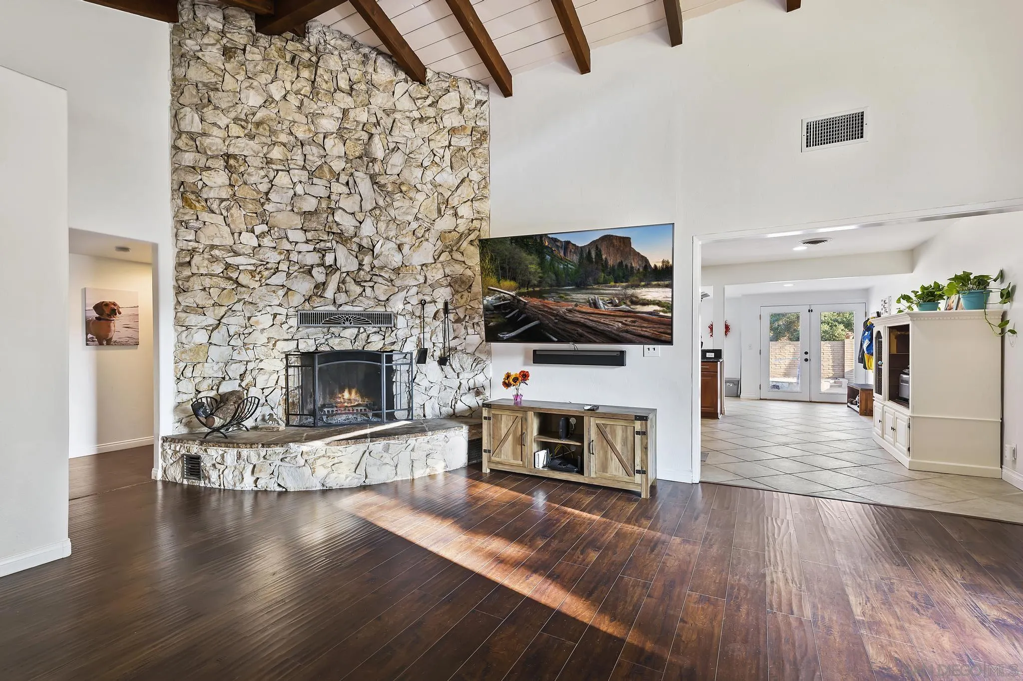 14725 Lyons Valley Road Jamul, CA 91935 - Photo 3 of 57 a living room with a fireplace a flat screen tv and a fireplace