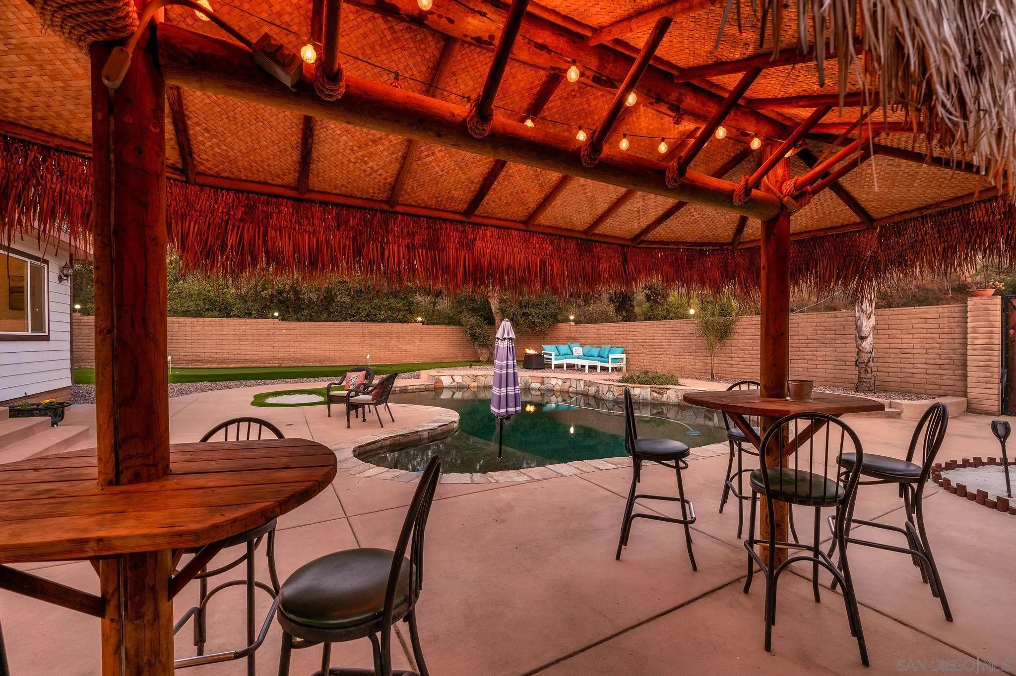 14725 Lyons Valley Road Jamul, CA 91935 - Photo 56 of 57 a view of a patio with table and chairs with wooden floor and plants