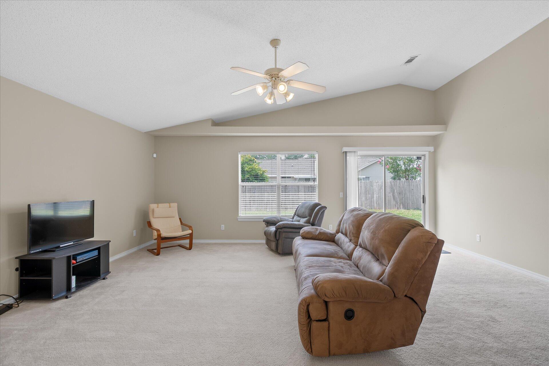 118 Sandstone Trail Crestview, FL 32539 - Photo 11 of 33 a living room with furniture and a flat screen tv