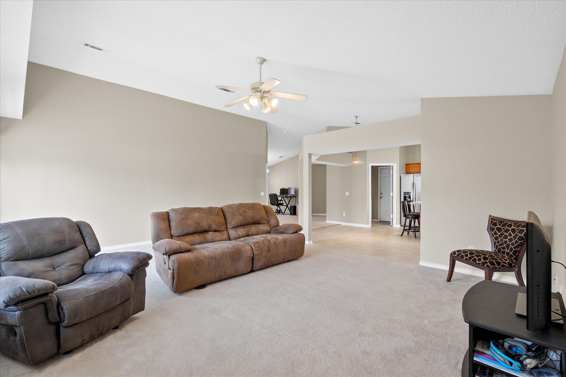 118 Sandstone Trail Crestview, FL 32539 - Photo 12 of 33 a living room with furniture a dining table and with couches