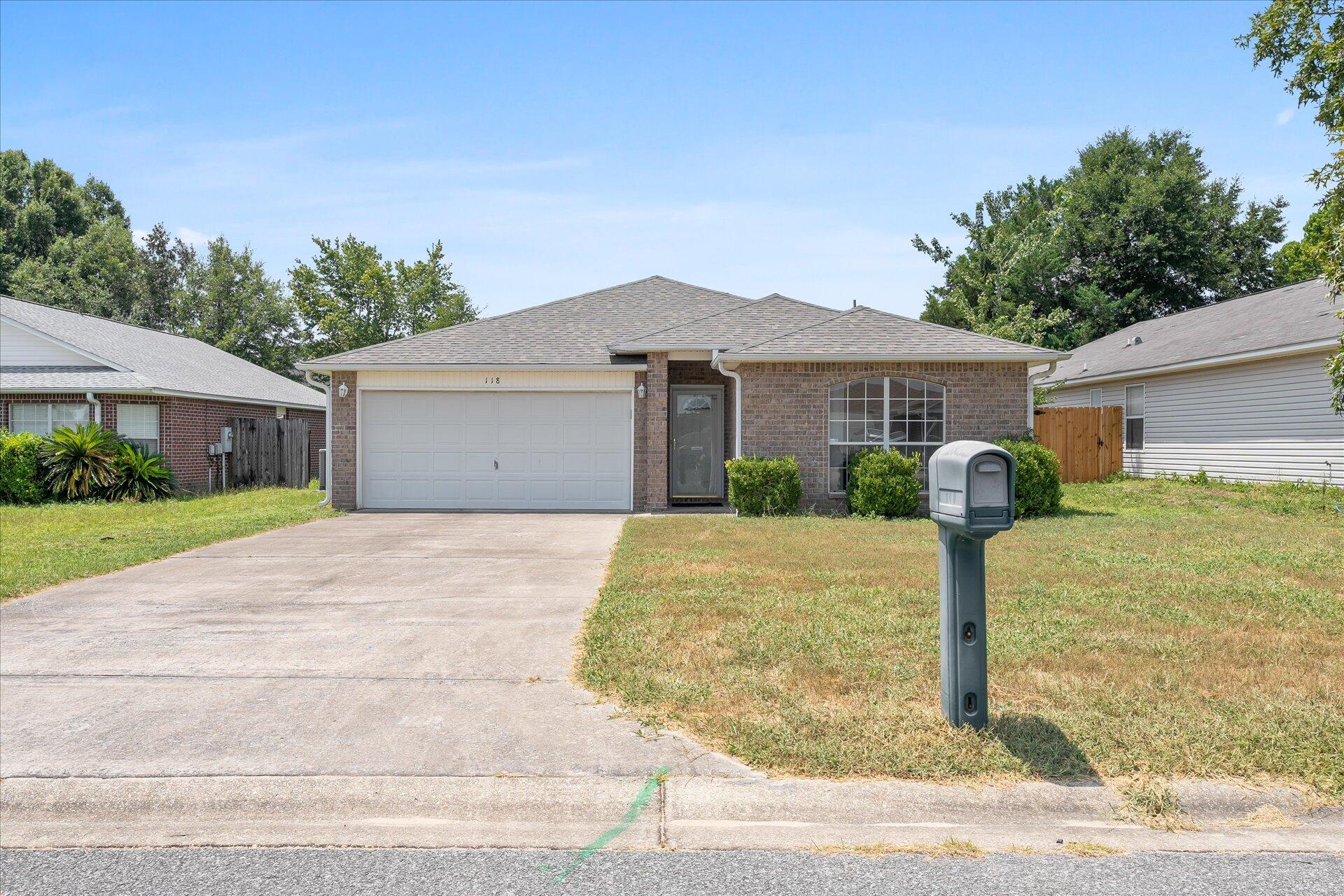 118 Sandstone Trail Crestview, FL 32539 - Photo 2 of 33 a front view of a house with a yard and garage