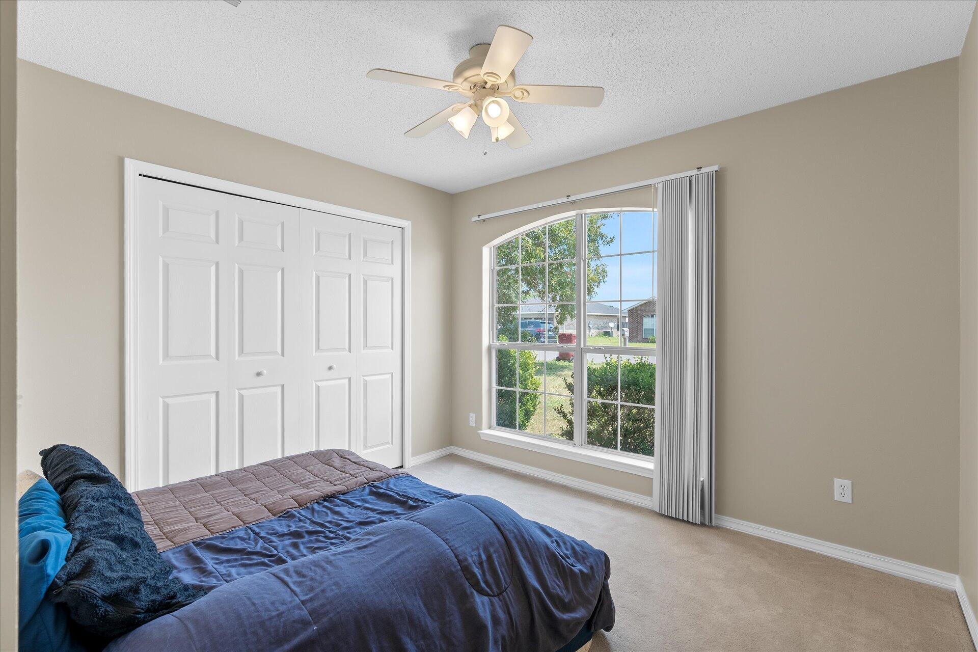 118 Sandstone Trail Crestview, FL 32539 - Photo 26 of 33 a bed sitting in a bedroom next to a window