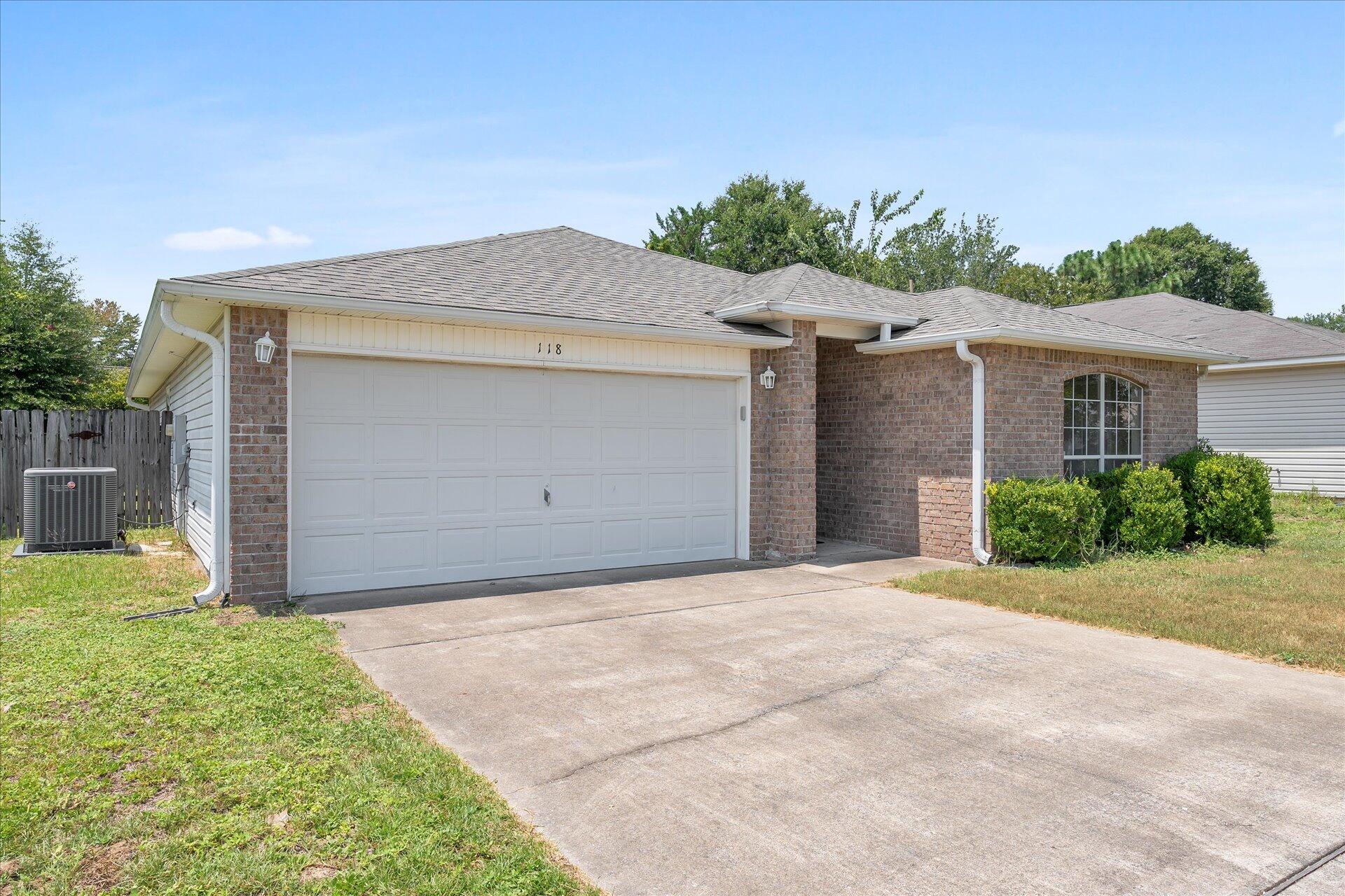 118 Sandstone Trail Crestview, FL 32539 - Photo 3 of 33 a front view of a house with a yard and garage