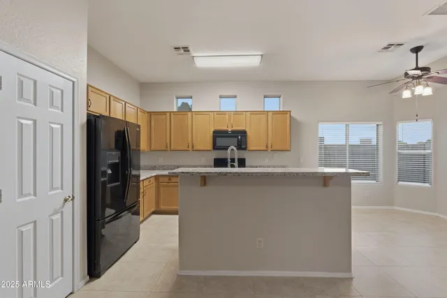 a kitchen with stainless steel appliances a refrigerator and a stove top oven