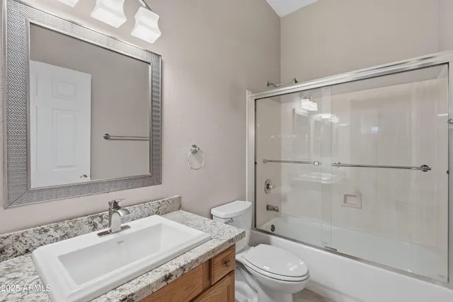 a bathroom with a glass shower door