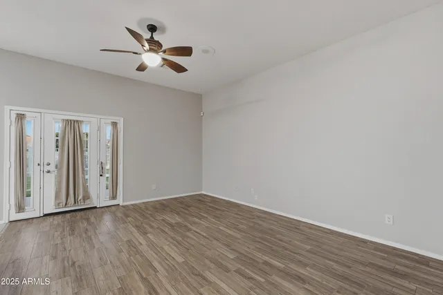 a view of empty room with wooden floor