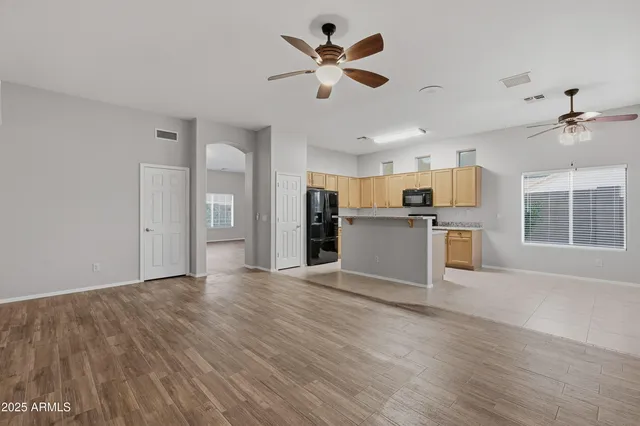 a view of a kitchen with wooden floor and a kitchen