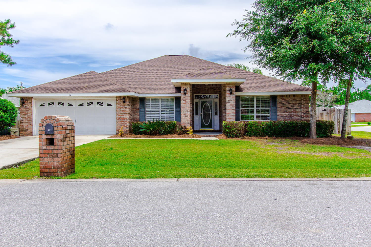 12 Inlet Drive Miramar Beach, FL 32550 - Photo 1 of 27 a front view of a house with a yard and garage
