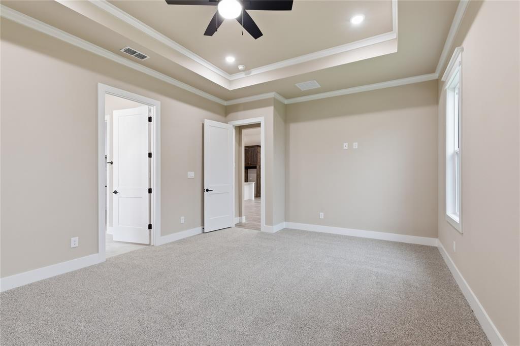 702 Anne Road Van Alstyne, TX 75495 - Photo 15 of 27 Spacious room featuring tray ceiling with recessed lighting and a ceiling fan, light-colored carpeting, and neutral wall paint