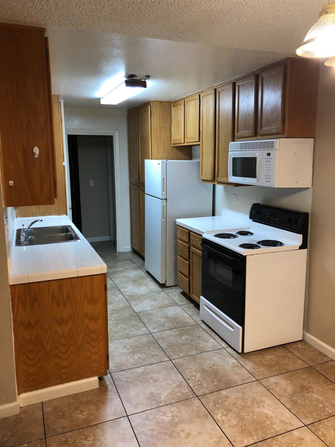 3025 Tully Road Modesto, CA 95350 - Photo 21 of 22 a kitchen with stainless steel appliances granite countertop a stove a sink and a refrigerator