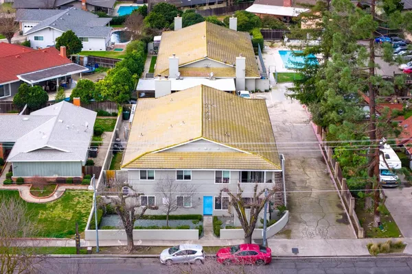 an aerial view of multiple houses with yard