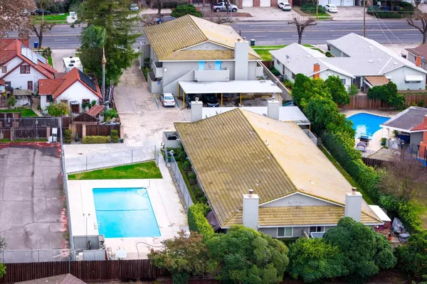 an aerial view of residential houses with outdoor space