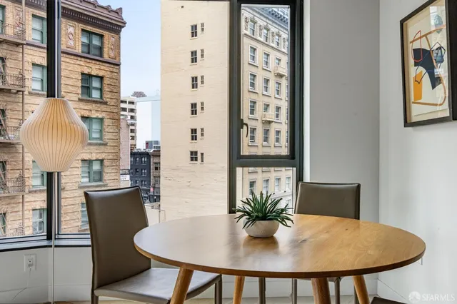 a view of a dining room with furniture and chandelier