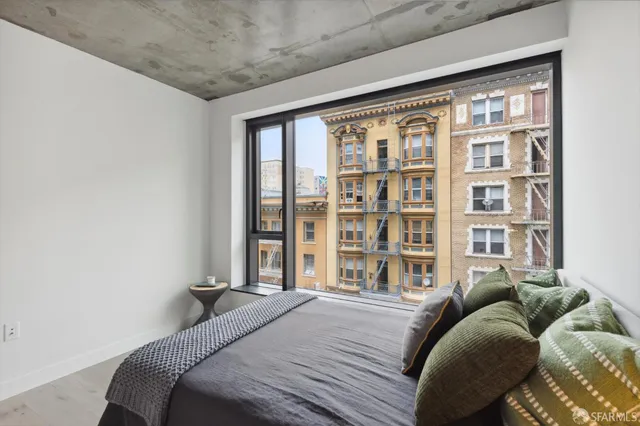 a bedroom with a bed and a large window