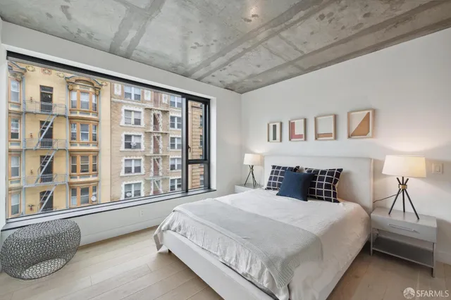 a bedroom with a large bed and a large window