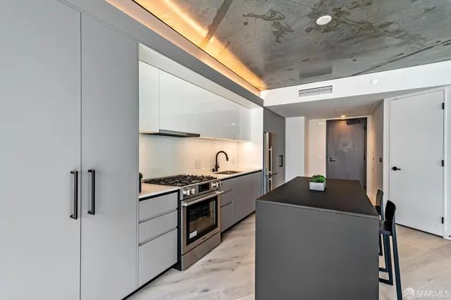 a kitchen with stainless steel appliances granite countertop a stove and a refrigerator