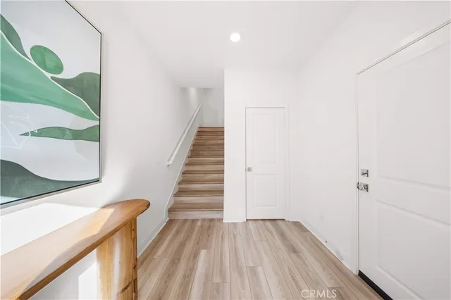 a view of an entryway with wooden floor