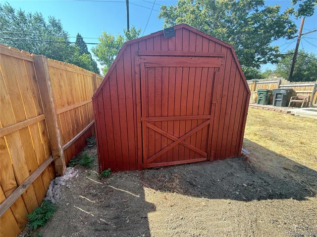 a view of a backyard with wooden fence