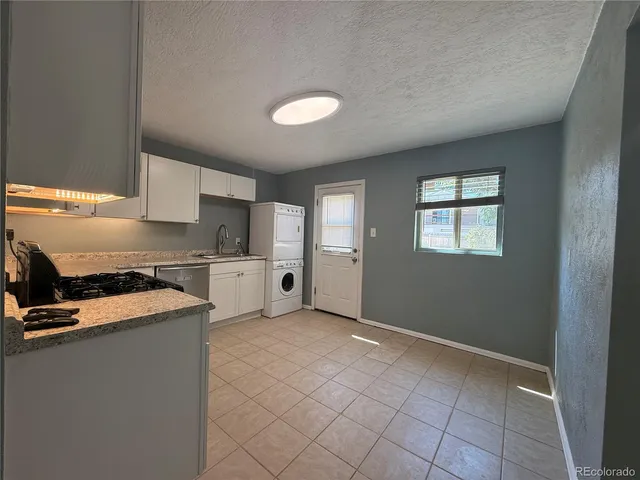 a view of a kitchen with a sink dishwasher and a refrigerator