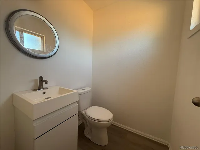 a bathroom with a toilet a sink and a mirror