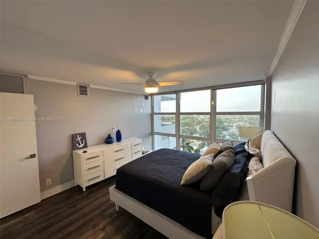 a bed room with a bed and a large window