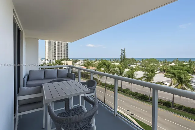 a view of a balcony with furniture