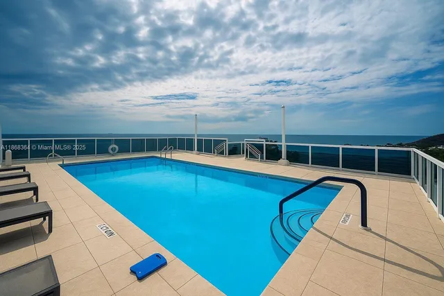 a view of a swimming pool with an outdoor seating