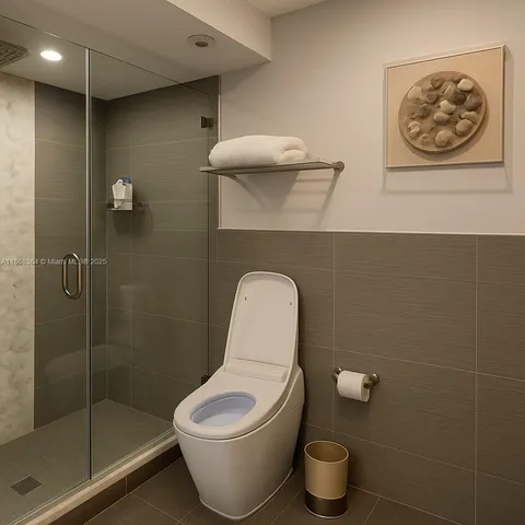a bathroom with a toilet and a shower