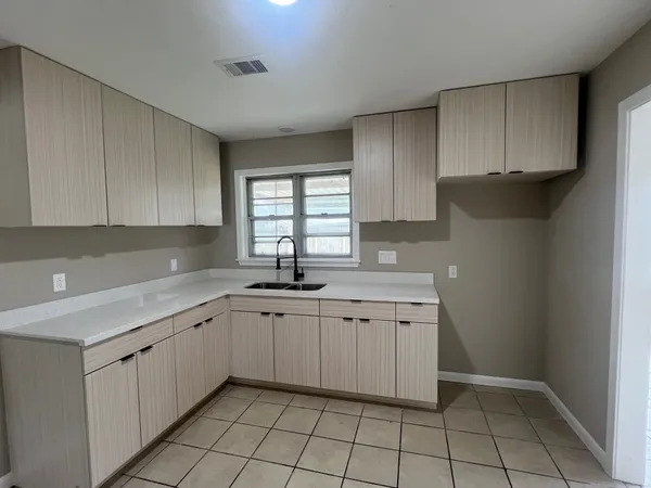 a kitchen with a sink and cabinets
