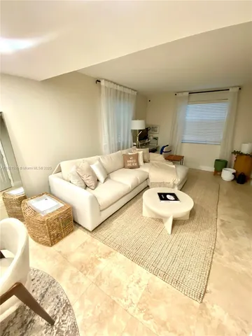 a living room with furniture and a rug