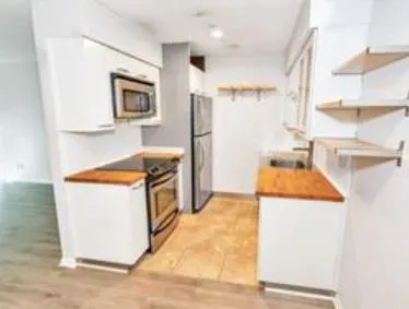 a kitchen with a stove a sink and a refrigerator