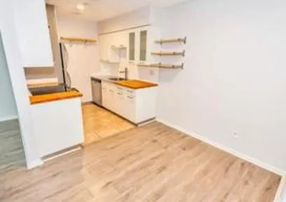a room with a sink and a refrigerator
