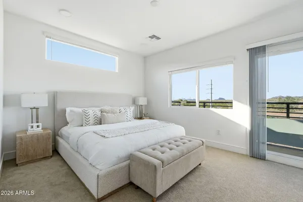 a bedroom with a bed and a night stand