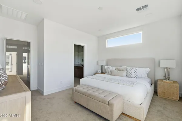 a bedroom with a bed and a window