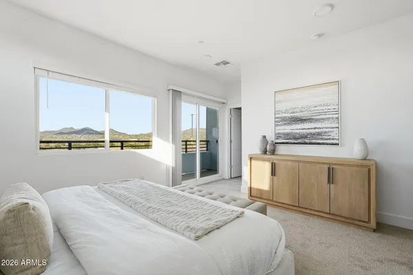 a bedroom with a bed and night stand