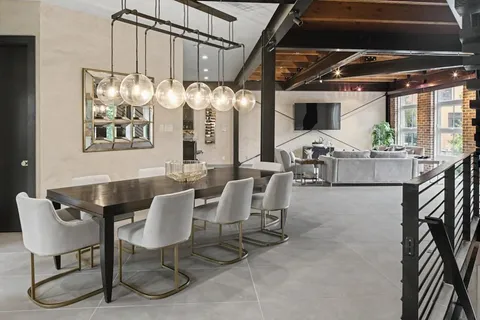 a dining room with furniture a chandelier and window
