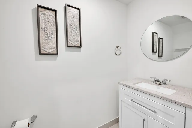 a bed sitting in a spacious bedroom next to a window
